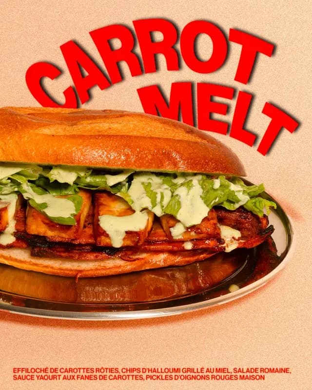 Carrot Melt sandwich with roasted carrots, grilled halloumi, romaine lettuce, and carrot top yogurt sauce on a toasted bun.