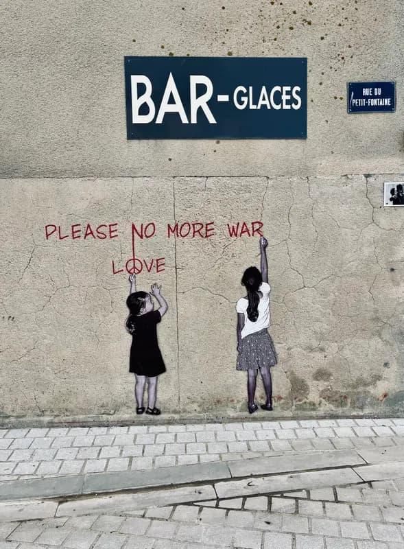 Street art on Bar-Glaces wall in Paris showing two children writing "Please No More War, Love" with peace symbol.