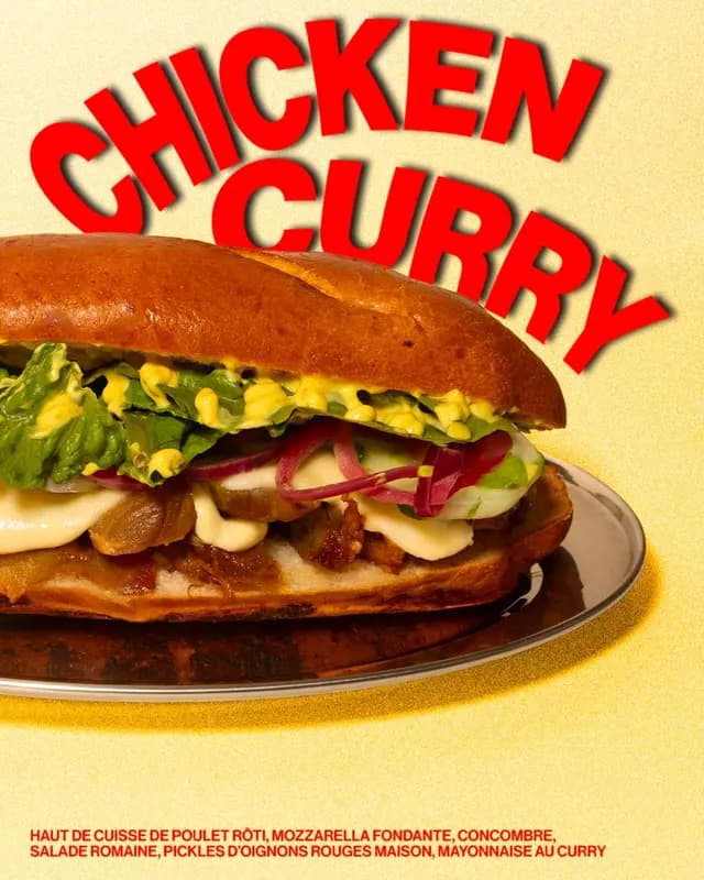 Chicken Curry sandwich with roasted chicken thigh, melted mozzarella, pickled red onions, romaine lettuce, and curry mayo on a brioche bun.