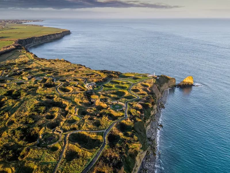 Pointe du Hoc WWII cliff-top memorial site in Normandy, France, with bomb craters and ocean views